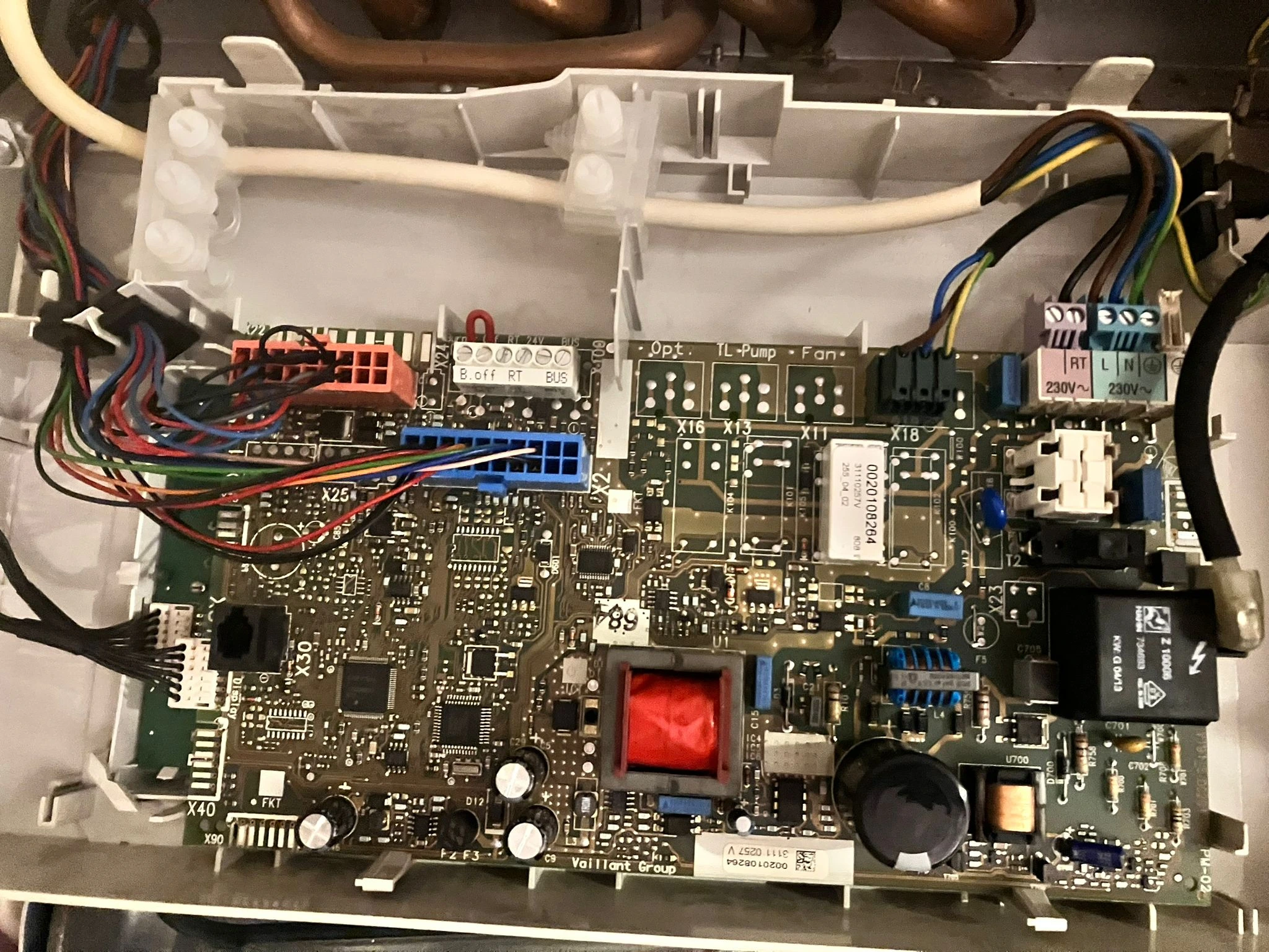 Gas Safe engineer repairing a combi boiler in Bury a control unit being replaced