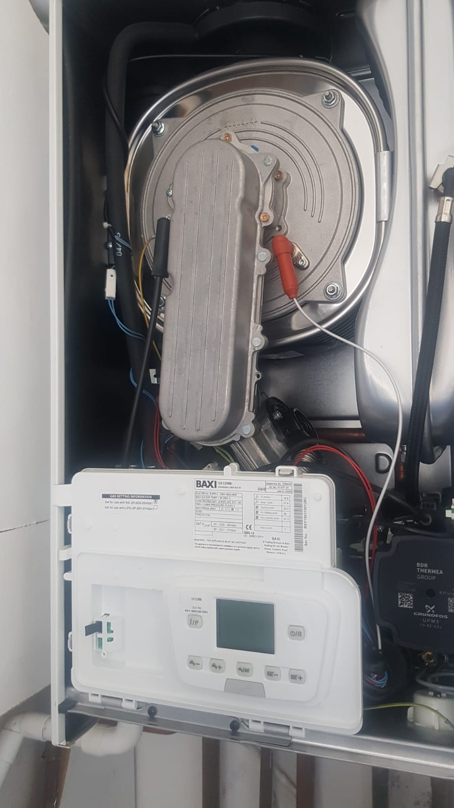 Gas Safe engineer repairing a combi boiler in Rochdale. Combustion checks and parts replacement